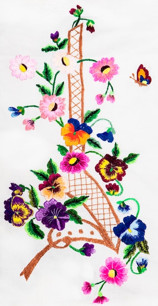 hands embroidering floral pattern